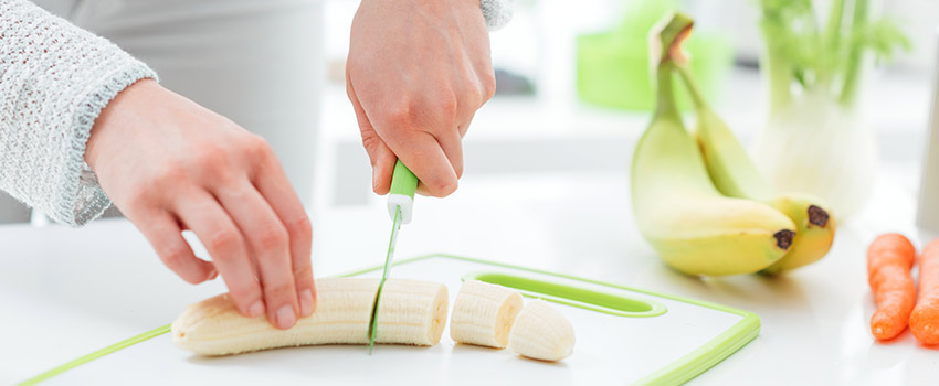 Woman slicing a banana