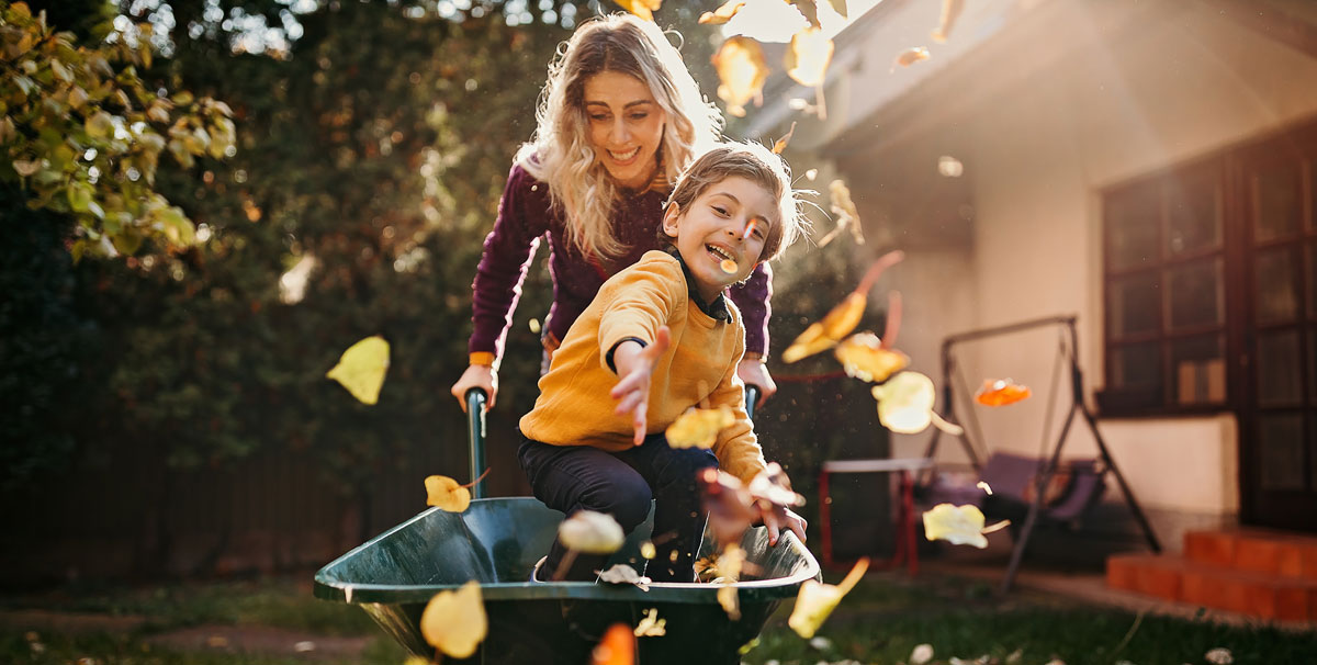 mom and son playing with wheelbarrow